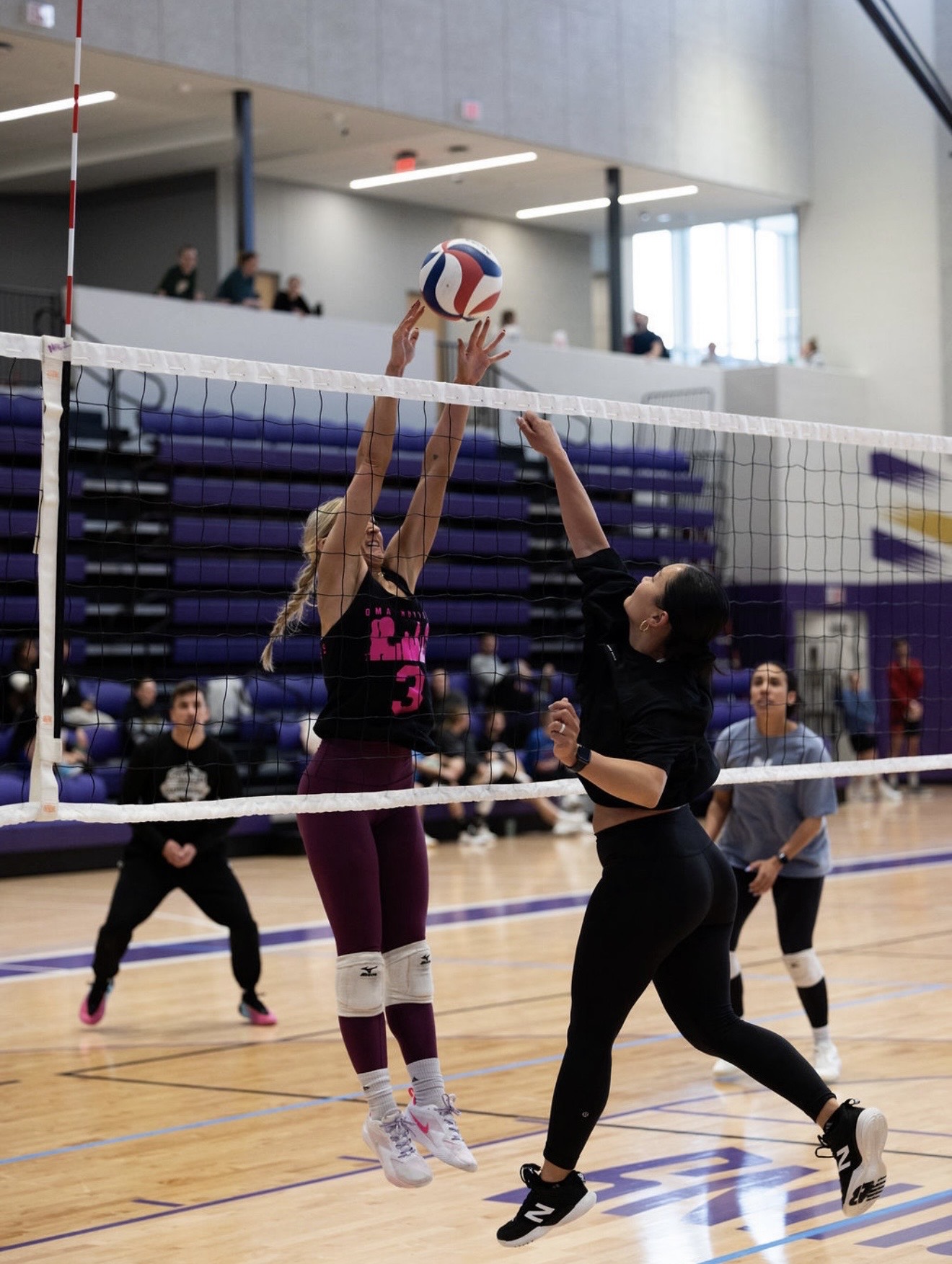 Omahotties player going up for a block at the net