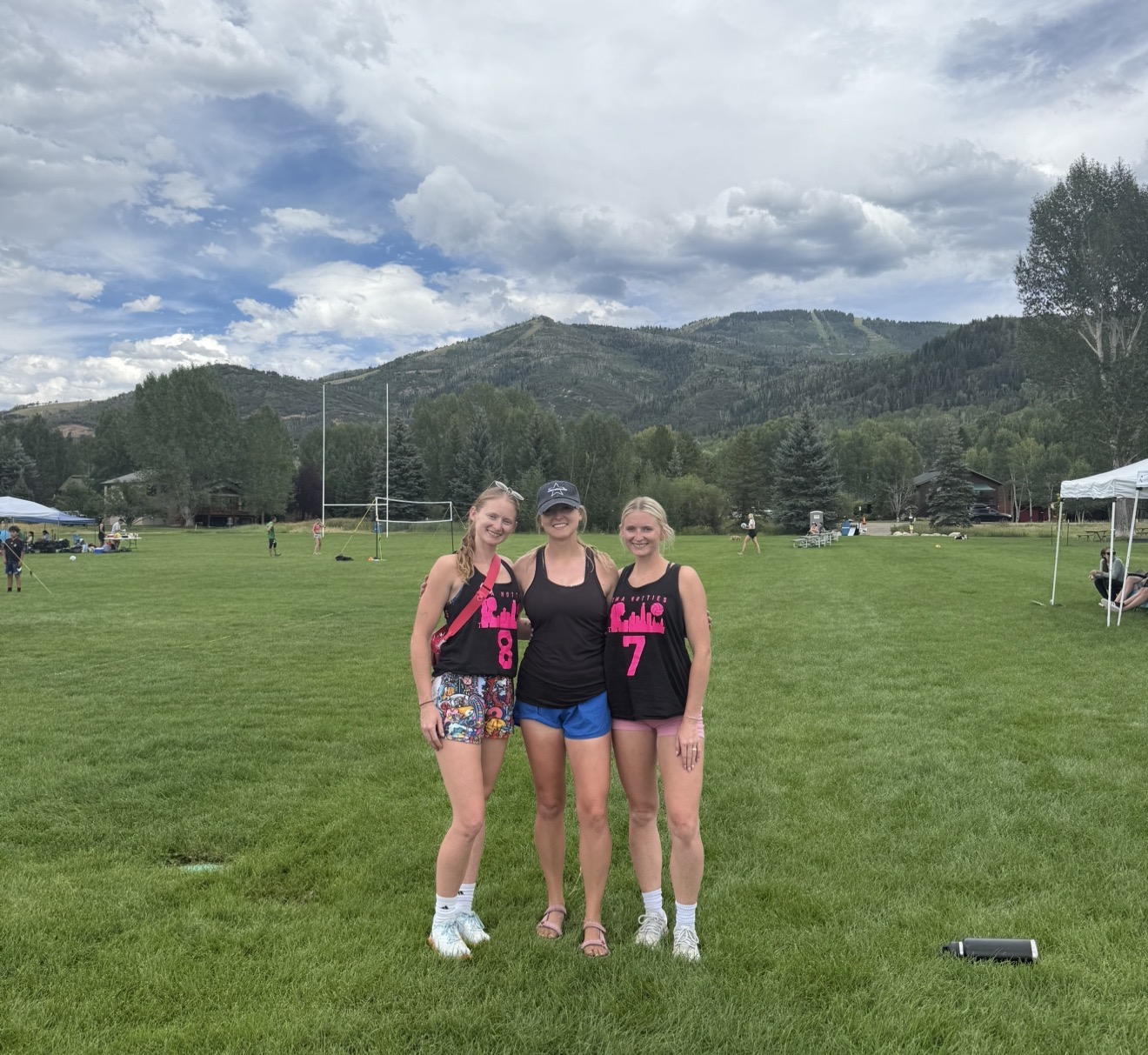 Omahotties teammates at a mountain-side outdoor tournament